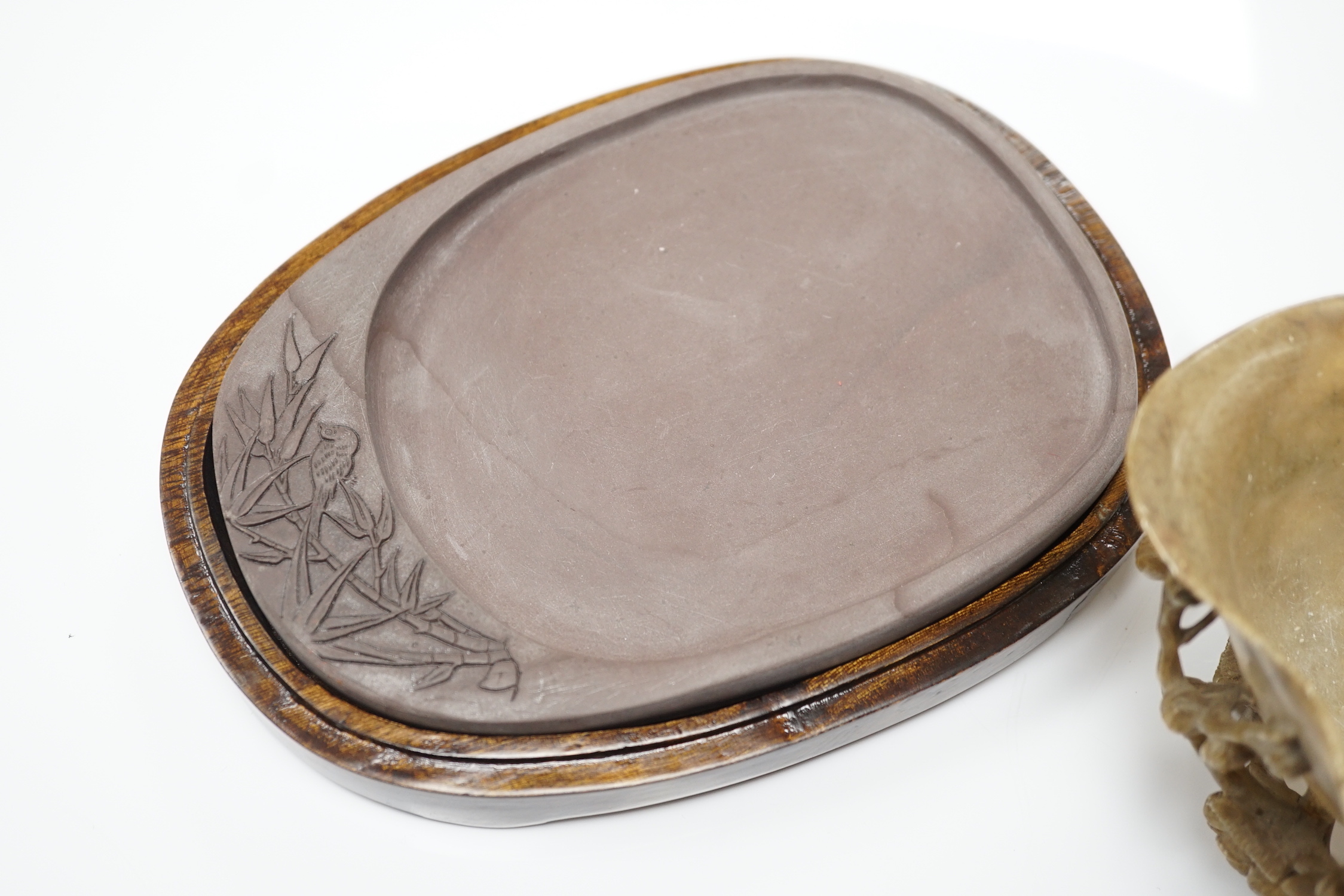 A Chinese carved soapstone libation cup, late 19th century and an elm cased inkstone
